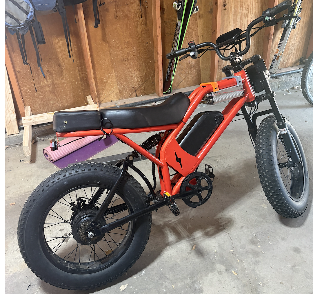 The finished red e-bike in the garage.
