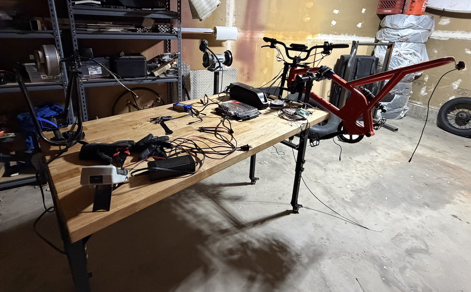 The bike frame and parts laid out on a table for testing.