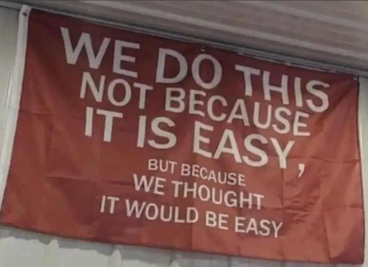 A workshop banner that says we do this not because it is easy, but because we thought it would be easy.