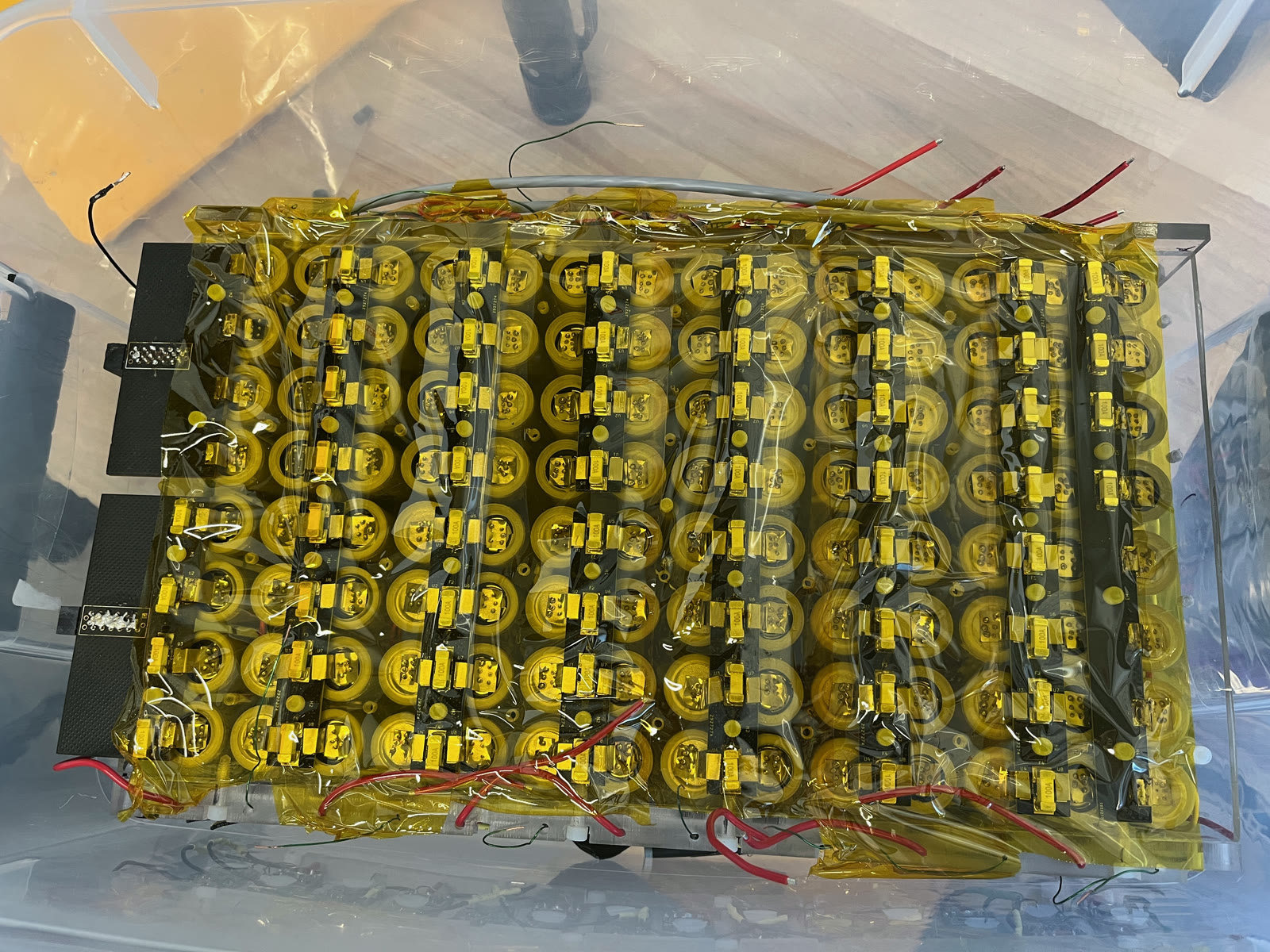 A 112-cell accumulator segment covered with fuse boards and insulation.